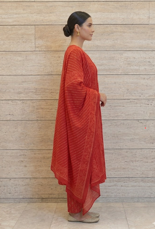 Red Anarkali suit side view showing high-low hemline and printed dupatta